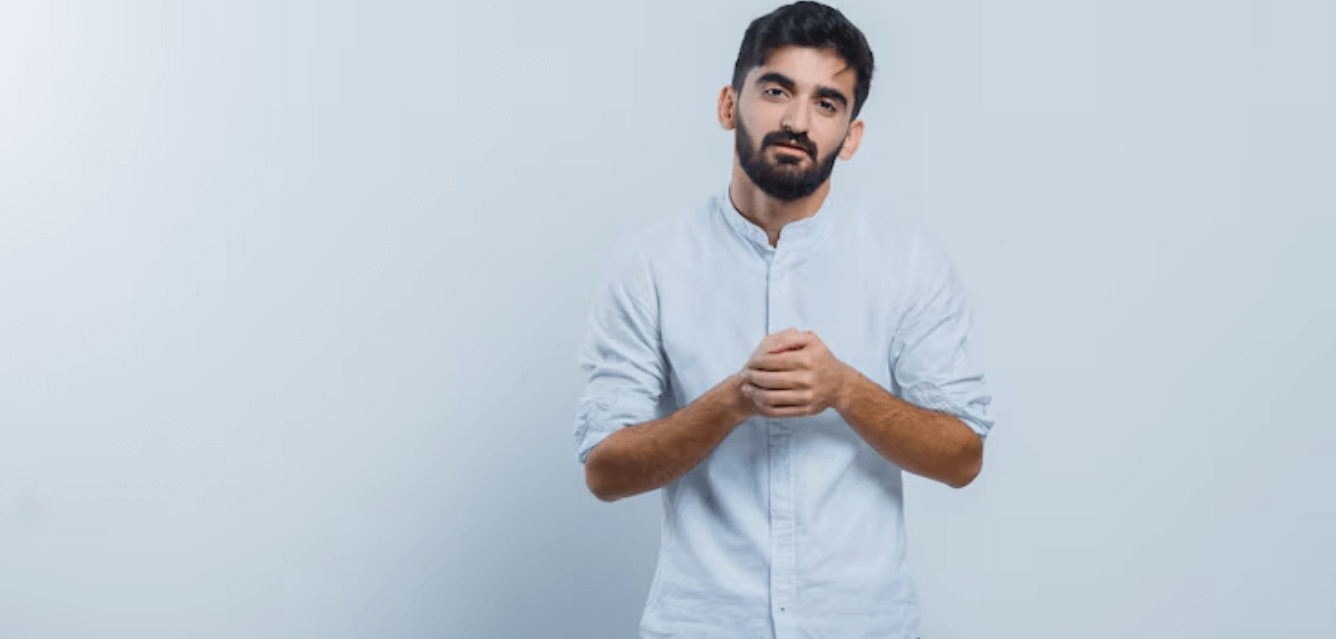 Adult man in a light shirt against a plain studio background